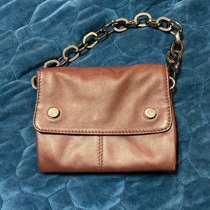 Rich dark burgundy leather bag with gray black metallic hardware. Small handbag